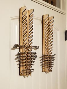 two wooden racks holding knives hang from the front door