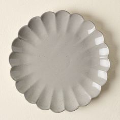 an empty white plate hanging on the wall