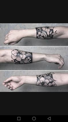 the arm is covered in black ink with flowers and leaves on it, as well as an