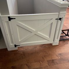 a wooden floor with a white fence on it's side and some black handles