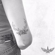 a woman with a flower tattoo on her arm