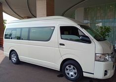 a white van parked in front of a building