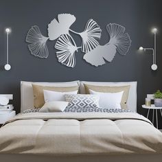 a bedroom with a bed, nightstands and wall art on the walls above it