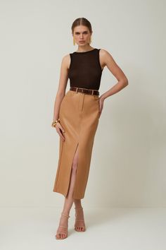 Allow This Closet Staple To Provide An Instant Update To Everyday Rotations. Crafted With Premium Leather, This Midi Skirt Emsuspenders An Off-Duty Aesthetic, While Corset-Style Seaming Adds Dimension To The Piece. Belt Loops And Lapels Add Understated Detailing This Piece. Style This Skirt With Heels And A Crop Top To Exude Understated Elegance At Your Next Event.Midi Hemlineleatherfront Leg Slitzip Fastening Leather Pencil Skirt Midi, Camel Leather Pencil Skirt, High Pencil Skirt, Mid Length Skirt Classy, Fall Pencil Skirts, Midi Leather Skirt Styling, Pencil Skirt Heeled Boots, Tan Skirt Cream Sweater, Bodycon Skirt Midi