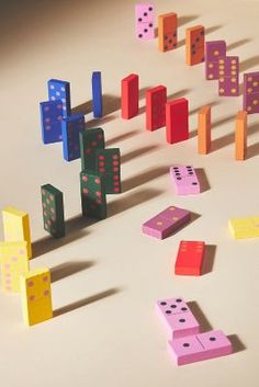 colorful dominos scattered on the floor with shadows