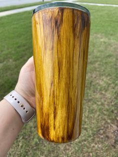 a person holding a wooden cup in their hand