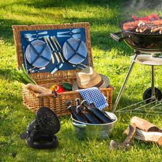 an outdoor bbq grill with barbecue tools on the grass