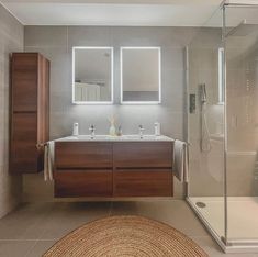 a bathroom with two sinks and a shower