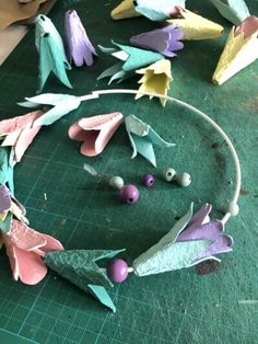 some paper flowers are laying on a cutting board and ready to be made into something