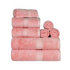 a stack of pink towels sitting next to each other on top of a white surface