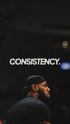 a man in black shirt and cap with the words constistency on it