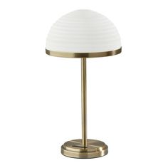 a white and gold table lamp on a metal base