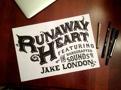 a piece of paper that says runaway heart on it next to some pens and a laptop