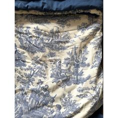 a blue and white toiler print bed spread