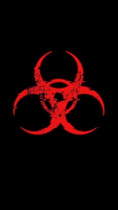 a red biohazard sign on a black background