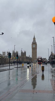 the big ben clock tower towering over the city of london on a rainy day in england