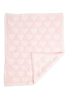 a pink and white blanket with hearts printed on it's side, folded in half