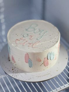 a white cake sitting on top of a metal rack