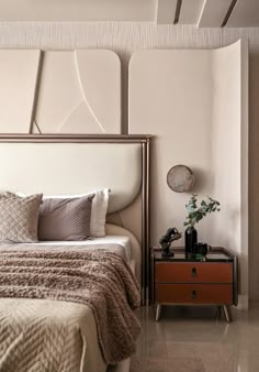 a bedroom with a bed, nightstand and mirror