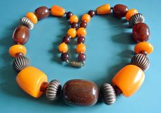 "Rare unique one-of-a-kind vintage 1980s necklace choker with oval brown resin plastic, rifled brass and jucey yellow catalin plastic beads - seamless beads on this necklace. Size:    23.5 \"/ inch or 52 cm long. Brass barrel clasp. Weight 104 gram. Exellent  vintage condition." Retro Brown Necklace For Gift, Vintage Orange Metal Necklaces, Vintage Orange Metal Necklace, Vintage Orange Metal Jewelry, Vintage Amber Jewelry With Large Beads, Vintage Metal Necklace With Large Beads, Vintage Polished Metal Bead Jewelry, Vintage Metal Jewelry With Polished Beads, Vintage Necklaces With Adjustable Oval Beads