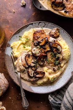 a plate with mashed potatoes and mushrooms on it