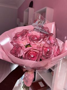 a bouquet of pink roses is wrapped in plastic