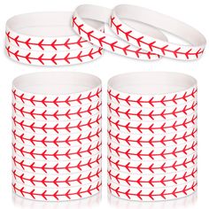 four red and white bracelets with arrows on them