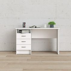 a white desk with three drawers in front of a brick wall and wooden flooring