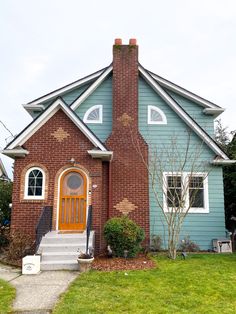 a blue and red brick house with white trim