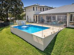 an above ground swimming pool surrounded by grass