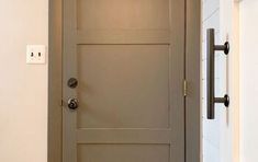 an open door in a house with white walls and wood trim on the bottom half