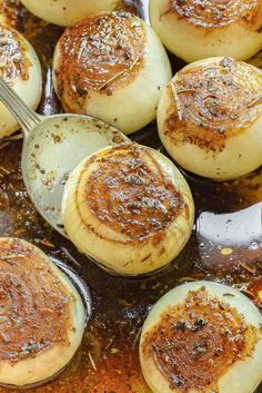 baked potatoes being cooked in a skillet with sauce and seasoning on top, ready to be eaten