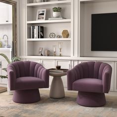 two purple chairs sitting next to each other in a living room