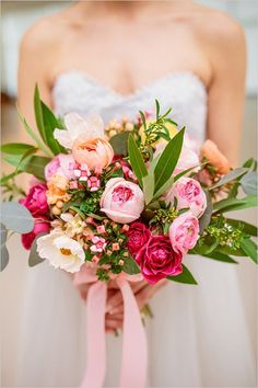 a bride holding a bouquet of flowers in her hands