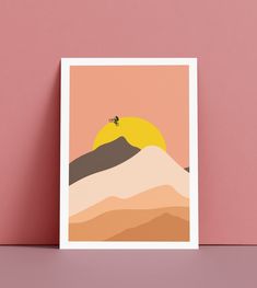 a card with an image of a mountain and a bee on it, against a pink background