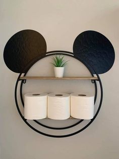 a mickey mouse head with three rolls of toilet paper