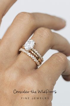 a woman's hand with two rings on it