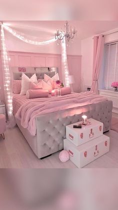 a bedroom with pink and white decor in the corner is lit up by fairy lights