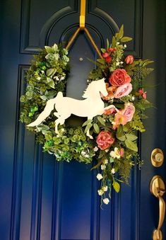 a door with a wreath on it that has a dog and flowers in the middle