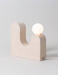 a white light sitting on top of a wooden block