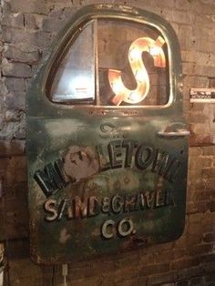 an old metal sign on the side of a brick wall that says, leton samgorme co