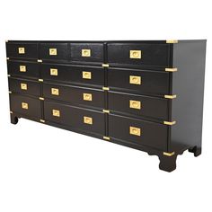 a black and gold dresser with many drawers