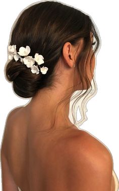 a woman with her back to the camera, wearing a white flower hair pin in her hair