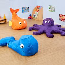 two large stuffed animals sitting on top of a wooden floor