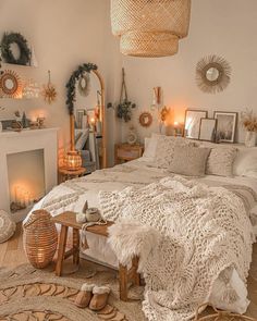 a bedroom with a large bed covered in blankets and pillows next to a fire place