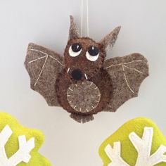 an ornament with a bat hanging from it's side