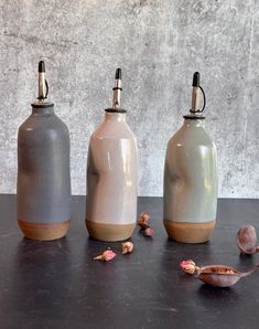 three vases sitting on top of a table next to each other