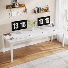 two white desks with numbered numbers on them in front of a window and a rug