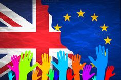 people raising their hands in front of the british and european flag with stars on it