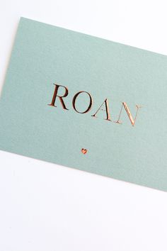 the word rowan written in copper foil on a light blue card that says rowan with a heart